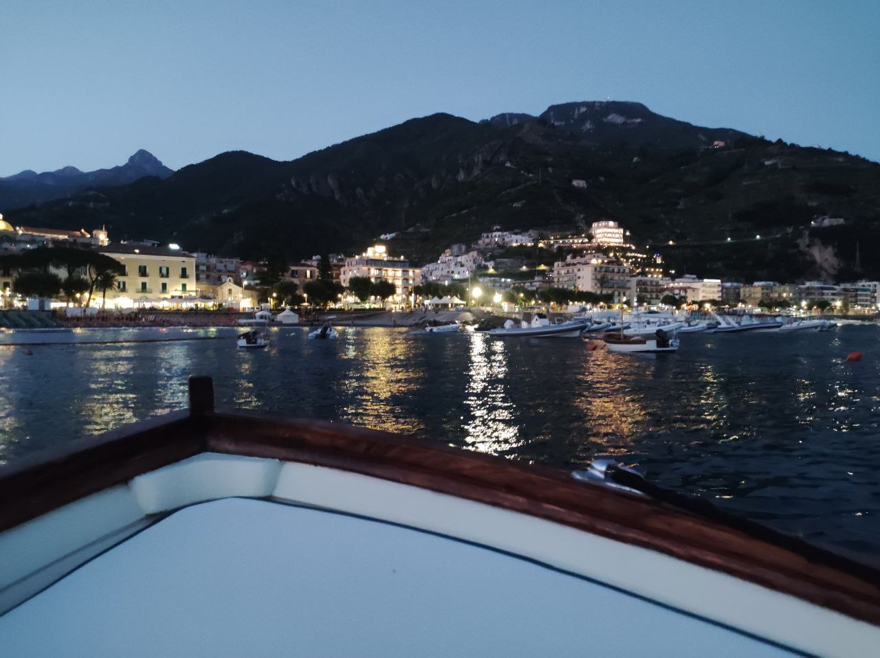 view of amalfi in the night from the boat 