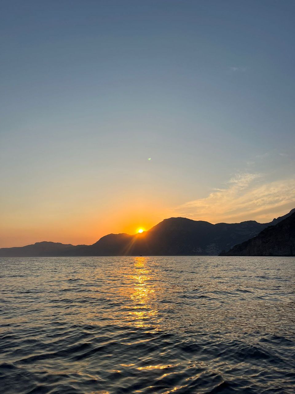 view of amalfi in the night from the boat 